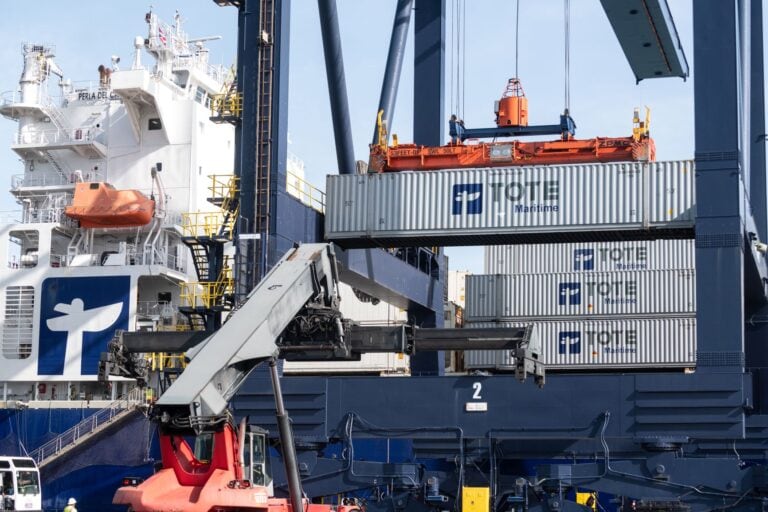 Loading containers onto a cargo ship at a port.