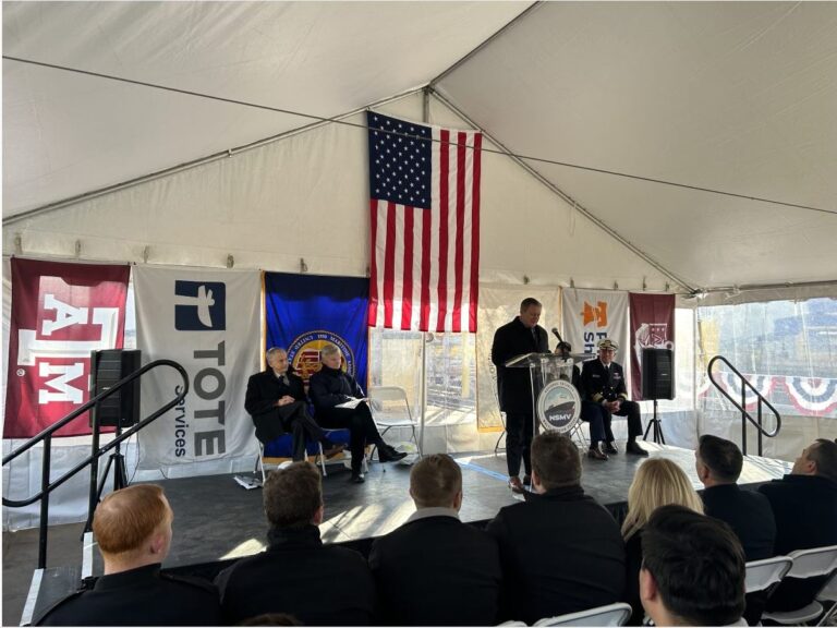 American flag hanging inside a tent during a formal event.