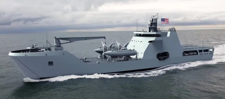 Large military landing ship sailing on the ocean with a cloudy sky.